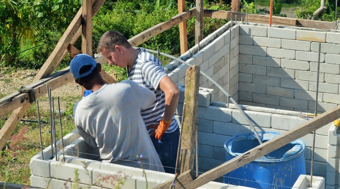A Projects Abroad volunteer is pictured with a local builder whilst rebuilding homes and schools as part of a disaster relief project during his building volunteer work in the Phillippines. Projects Abroad volunteer is pictured with a local building helping to rebuild homes and schools as part of a disaster relief project during his building volunteer work in the Phillippines.